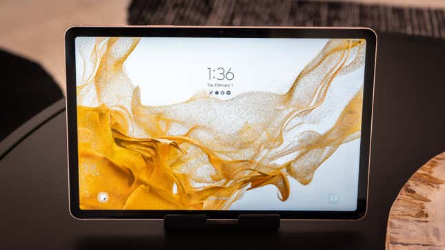 The Samsung Galaxy Tab S8 tablet propped up on a stand sitting on a table.