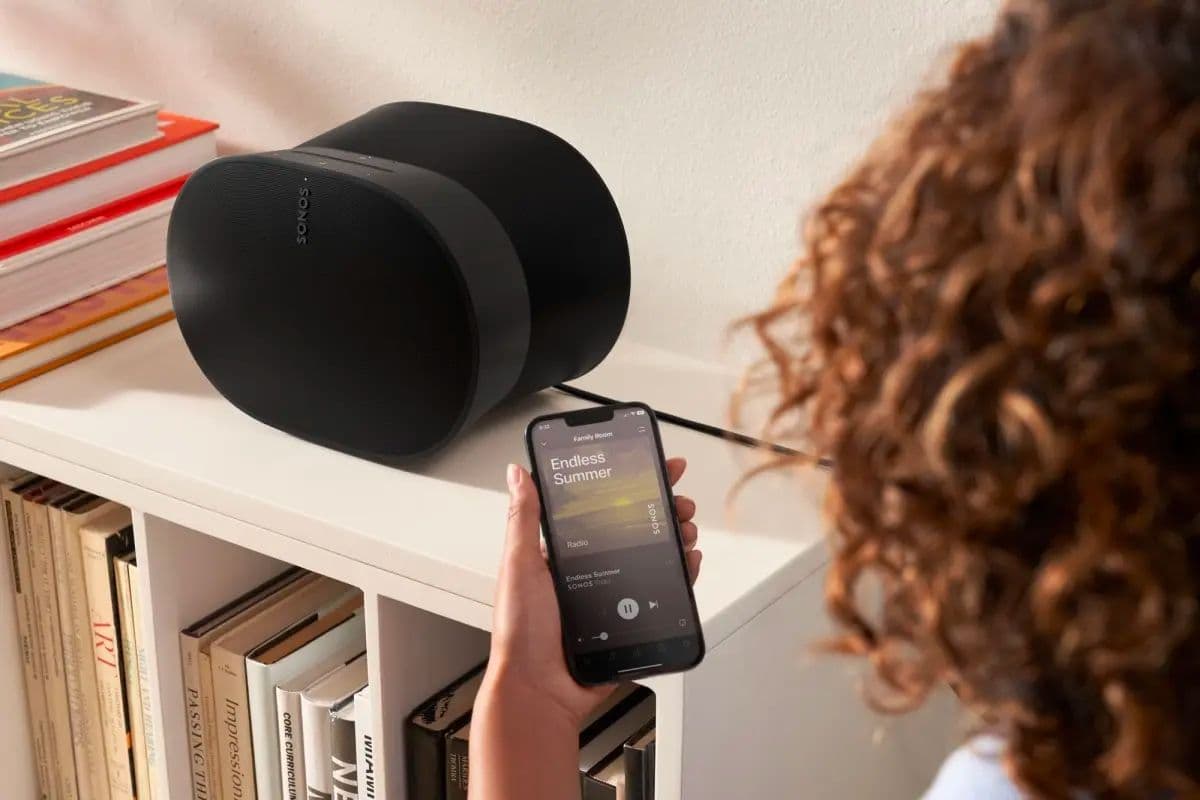 person-controlling-Sonos-Era-300-with-smartphone