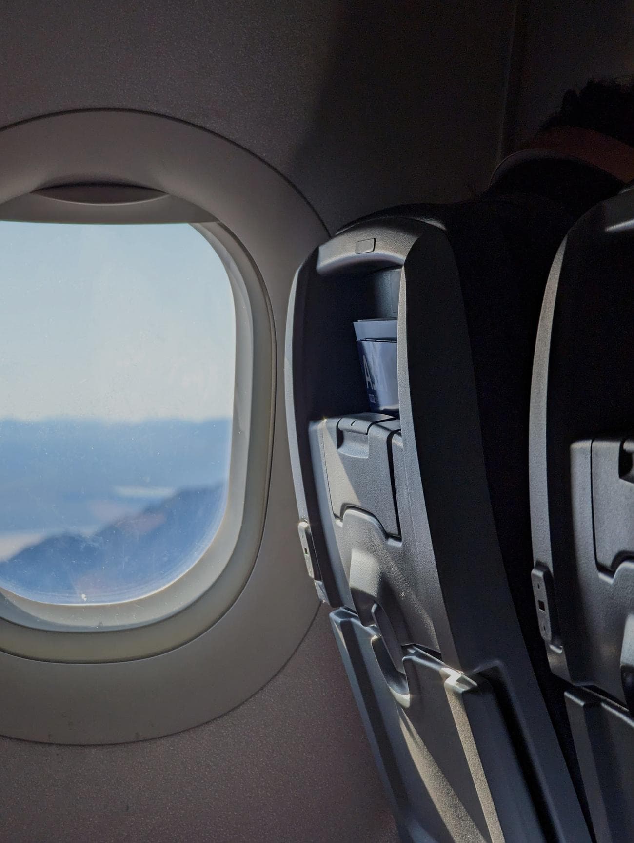 An airplane window and seat.