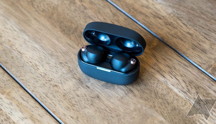 Sony WF-1000XM4 open case on a wooden table