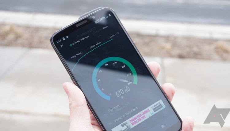 A 5G phone held in a hand