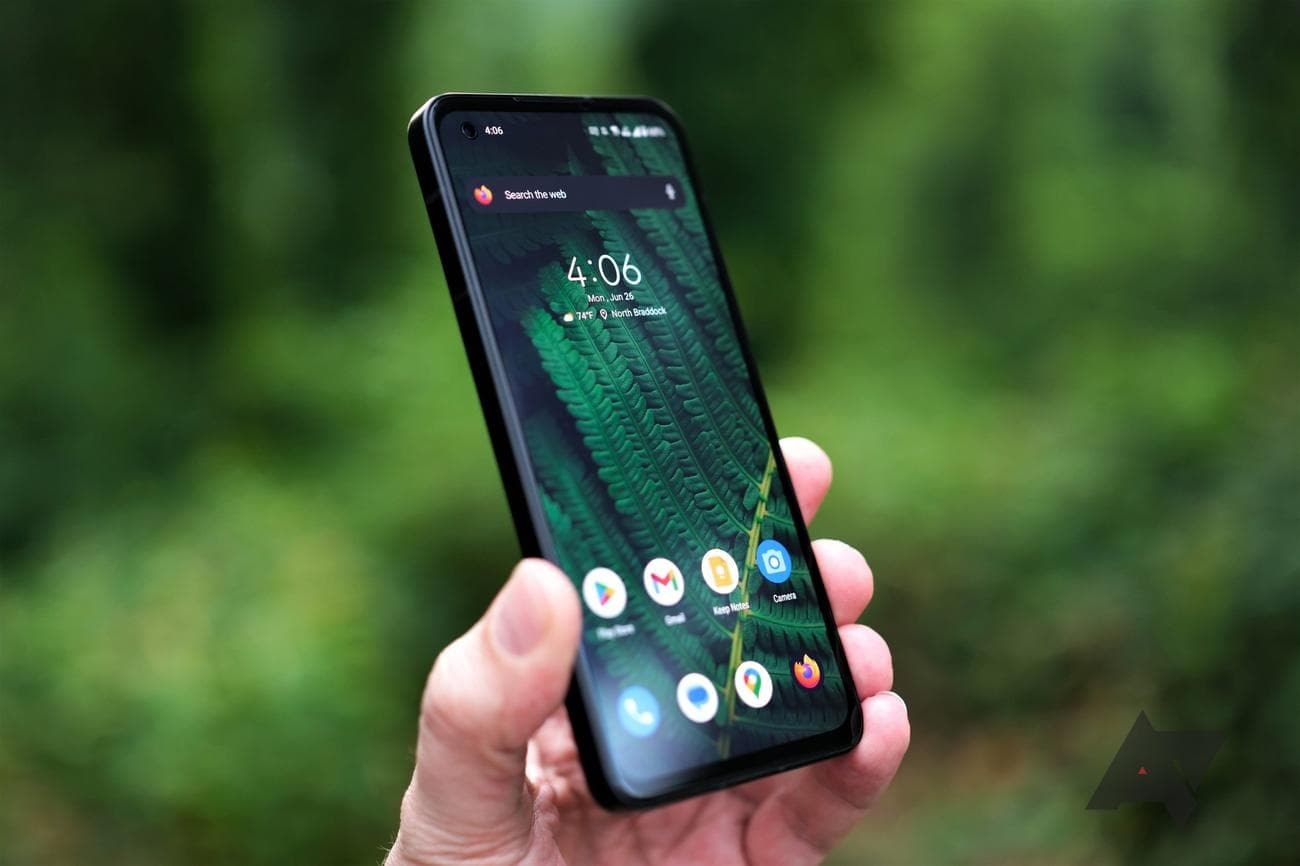 Asus Zenfone 10 held in hand at angle facing camera