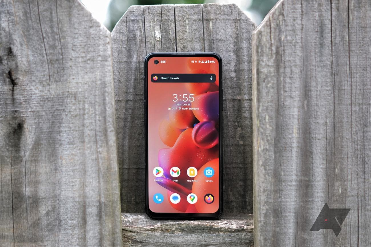 Asus Zenfone 10 perched on fence post with screen facing camera