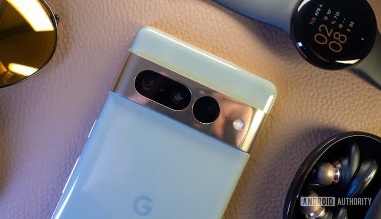 Google Pixel 7 Pro hazel next to Pixel Watch, wireless earbuds, and sunglasses
