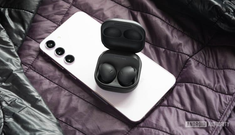 The samsung galaxy buds 2 pro earbuds and case on top of a Galaxy S23 Plus.