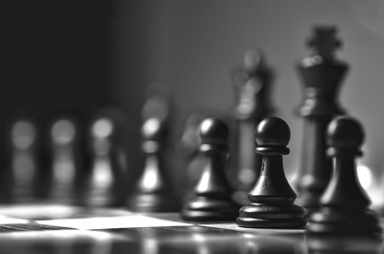 A closeup image of pawns on a chess board.
