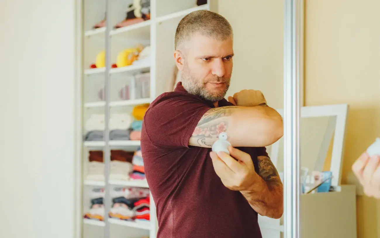 Man putting new sensor on the back of upper arm