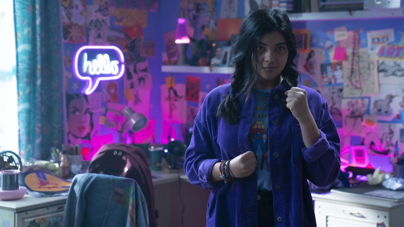 A teen girl holds her fists in combat mode in her bedroom.