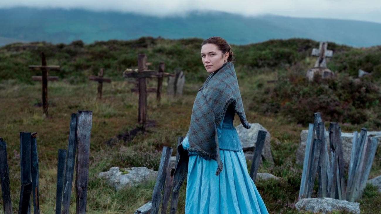 Florence Pugh stands in a graveyard in Ireland looking winsome in the film 