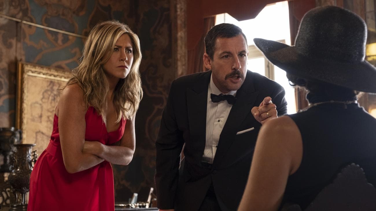 Jennifer Aniston and Adam Sandler point accusatory fingers at a seated Gemma Arterton in the film 
