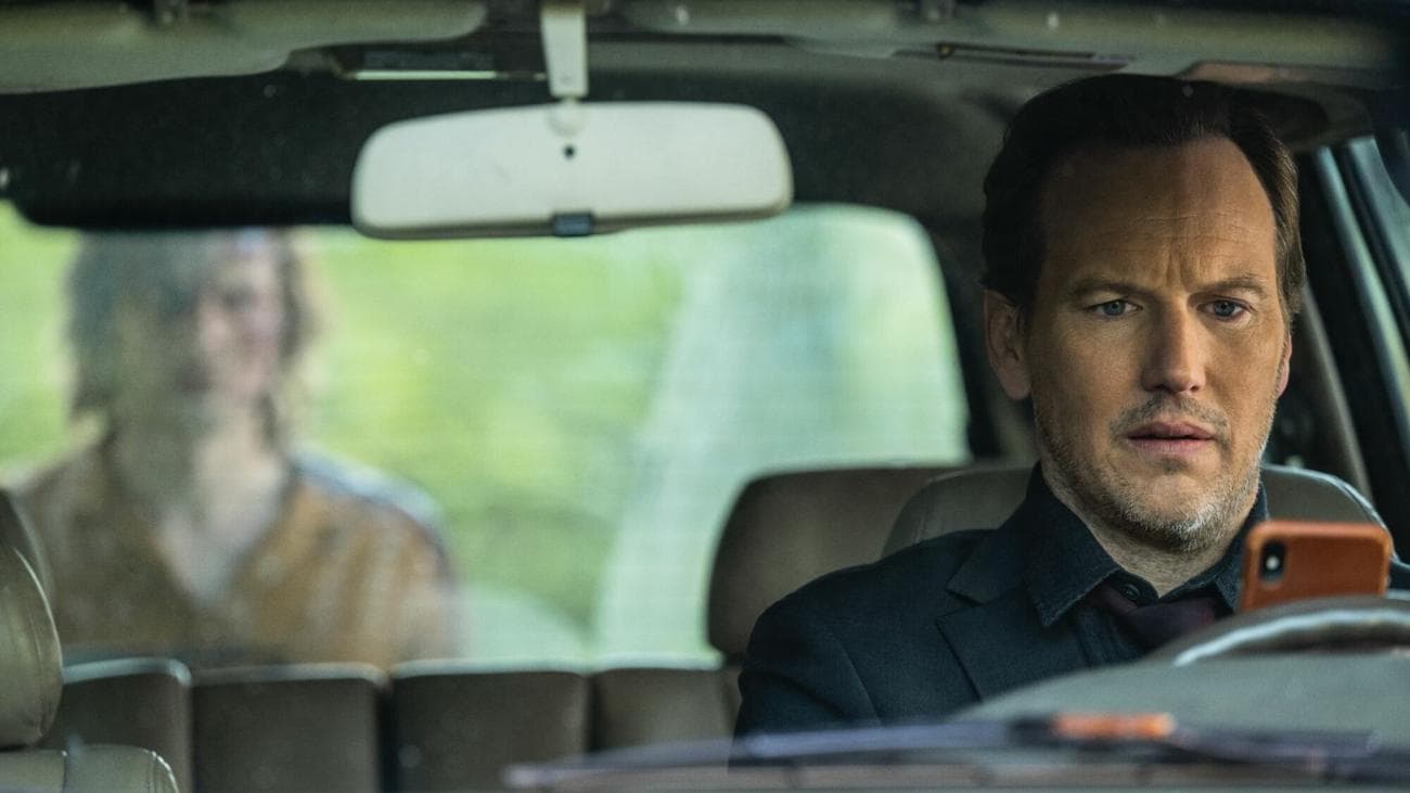 Patrick Wilson sits in a car, followed by a ghost in 