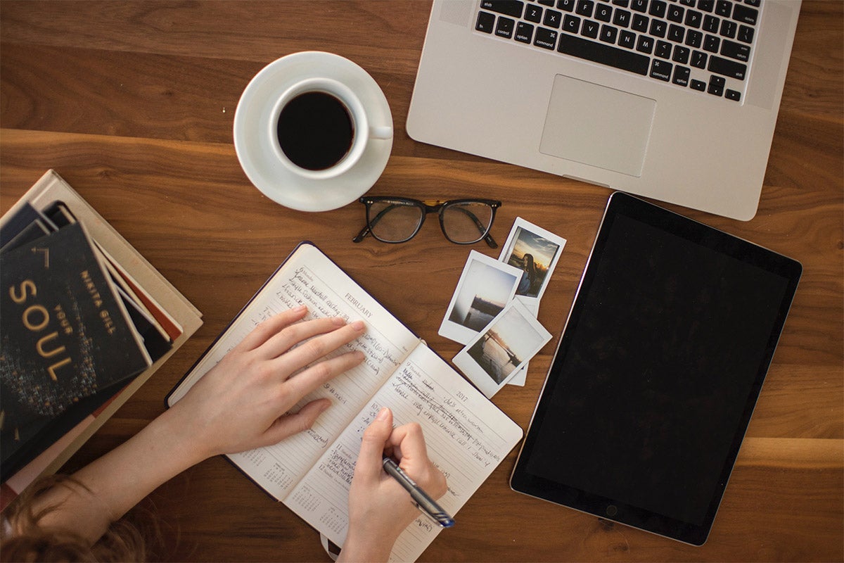 A person taking notes while sitting at a desk