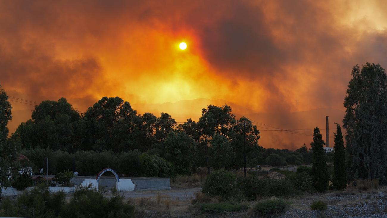 Smoke rises as teams try to extinguish wildfires on Rhodes island, Greece on July 25, 2023. Some 19,000 people have been evacuated from the Greek island of Rhodes as wildfires continued burning for a sixth day, authorities said on Sunday. As many as 266 firefighters and 49 fire engines were on the ground battling the blazes, assisted by five helicopters and 10 airplanes.
