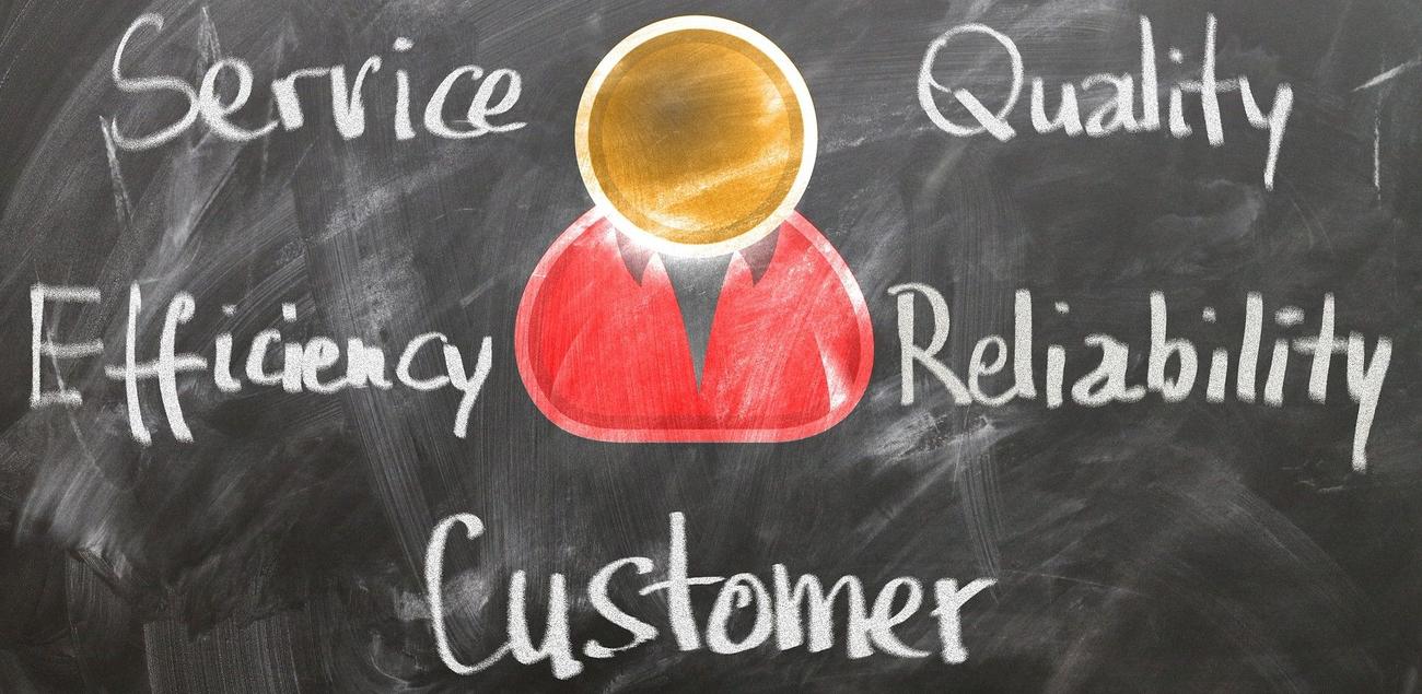 An icon of a person with the words service, quality, efficienty, reliability, and customer surrounding it