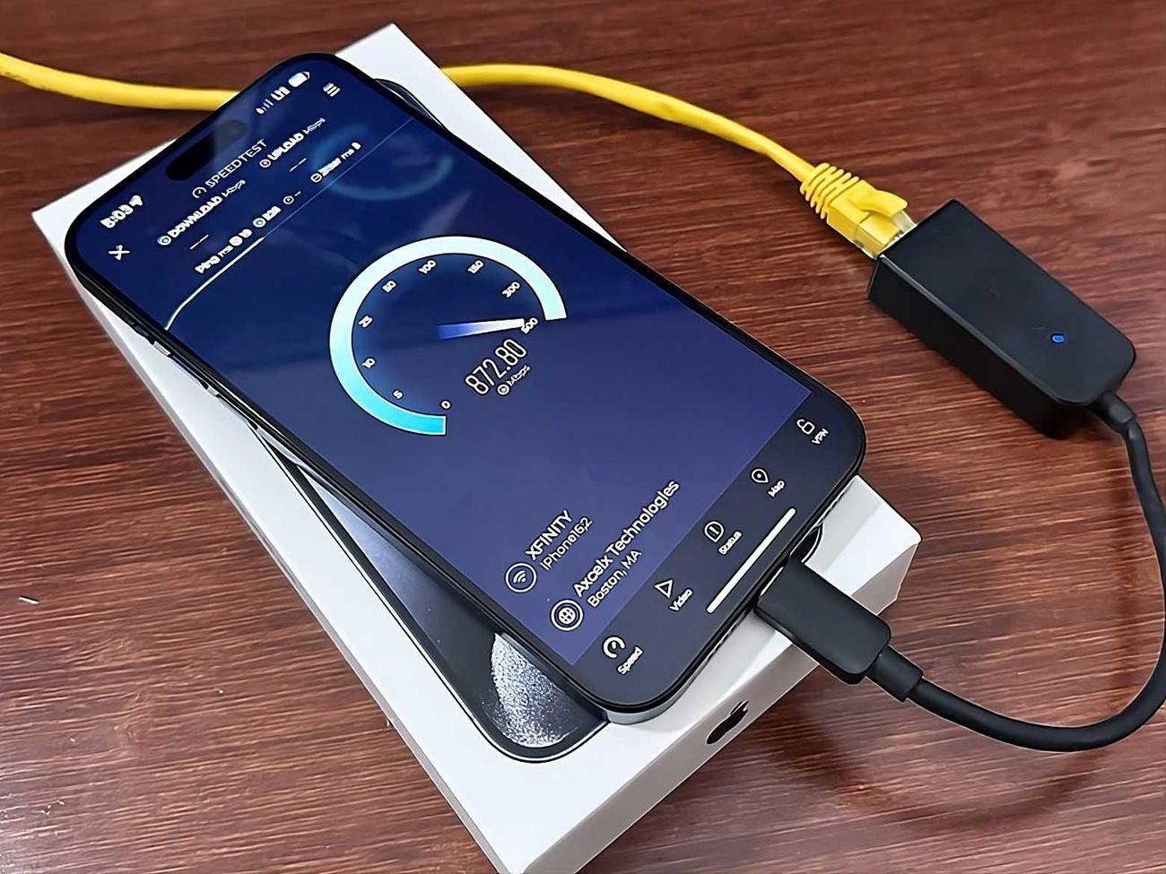 iPhone 15 connected to an Ethernet cable