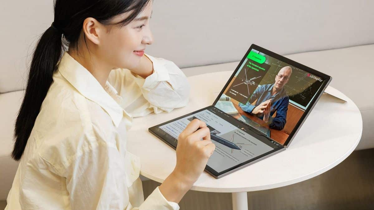 woman sitting at desk with foldable screen on table