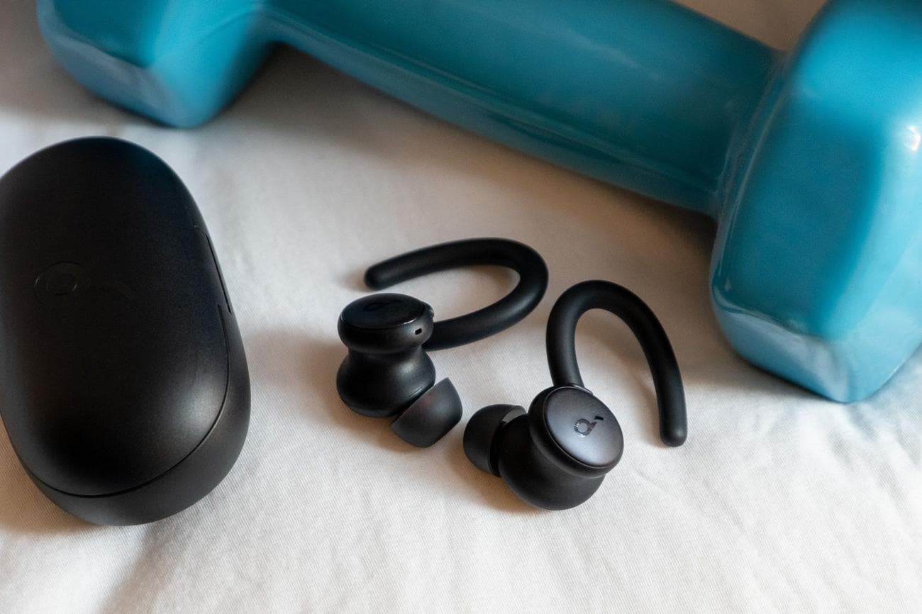 An image of Soundcore's Sport X10 earbuds next to a weight.