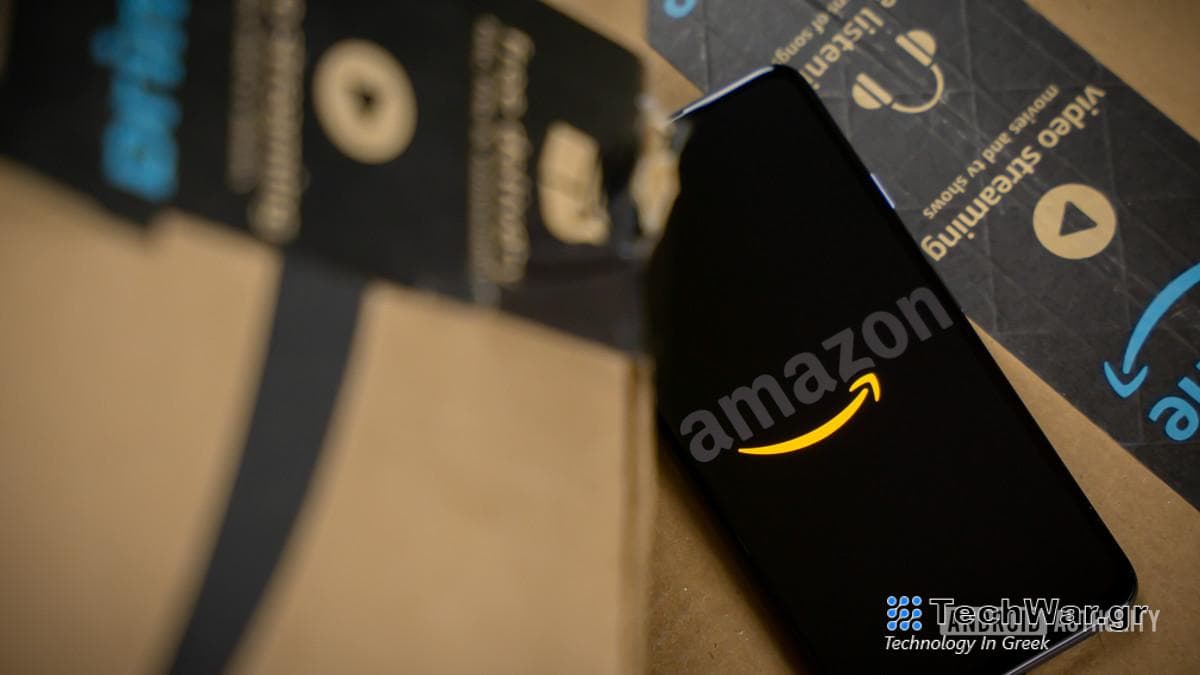 Amazon logo on phone next to boxes stock photo 16