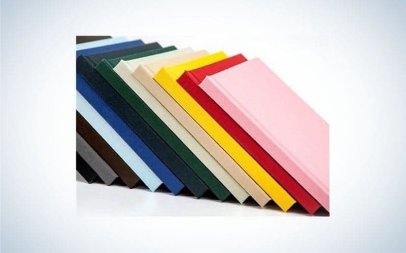 Some books are placed side by side, and all the books are in different colors.