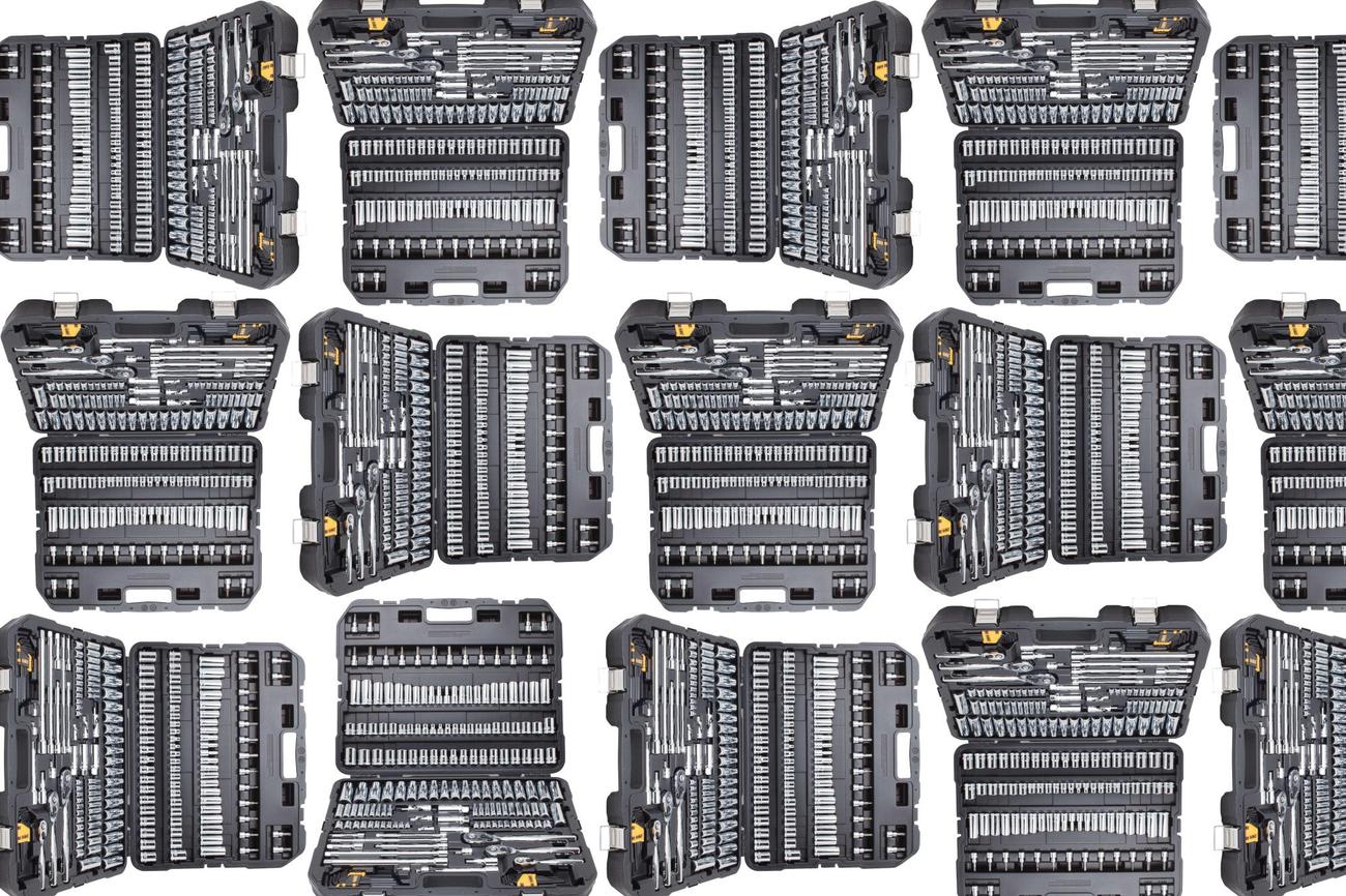 A DeWalt tool kit in a pattern on a plain background