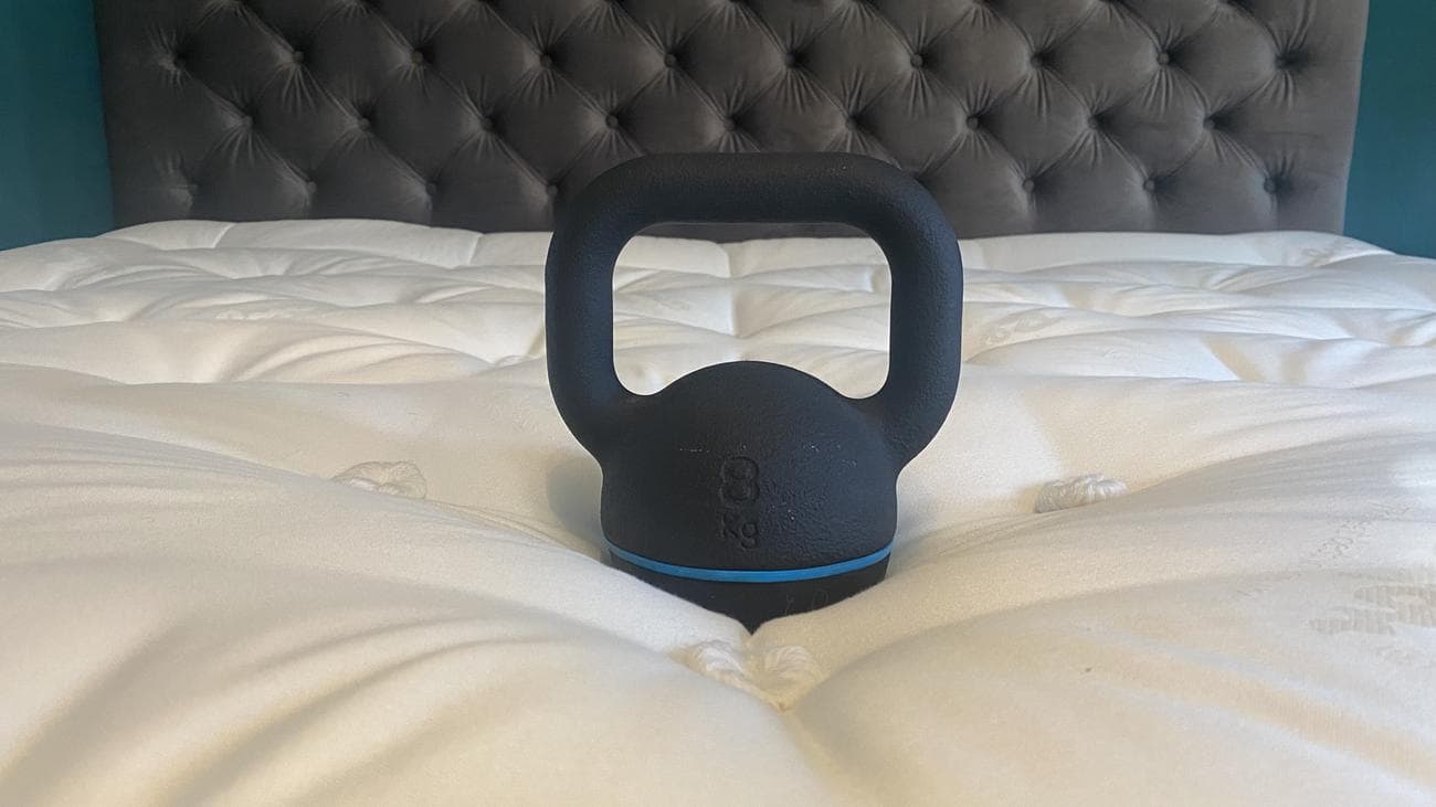 Relyon Bridgwater Dunlopillo Latex Mattress review image shows a heavy weight placed in the middle of the mattress to gauge the support and sinkage