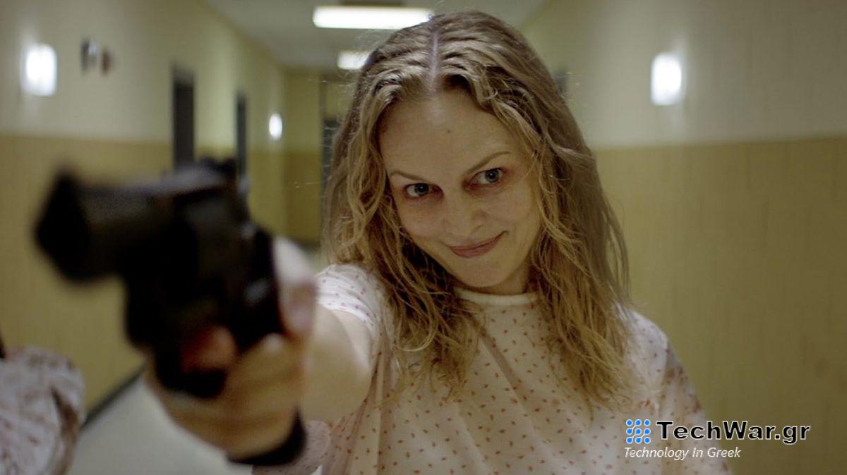 Heather Graham holding a gun and looking frantic in the movie Suitable Flesh