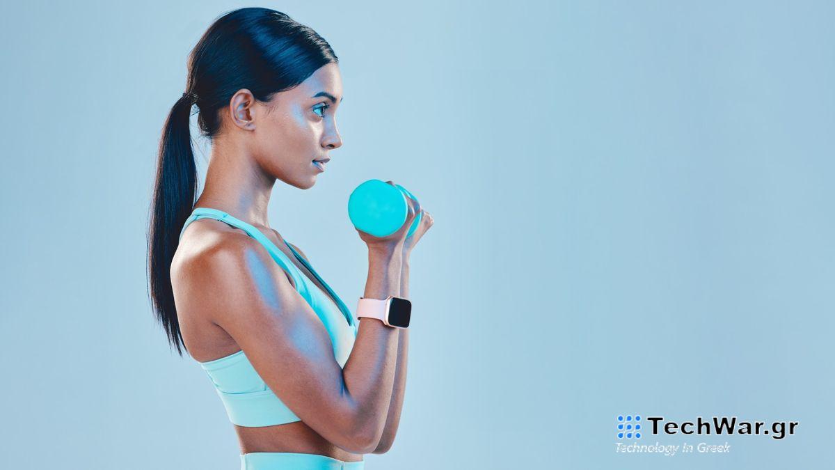 Woman facing side on to camera performing bicep curl with dumbbell