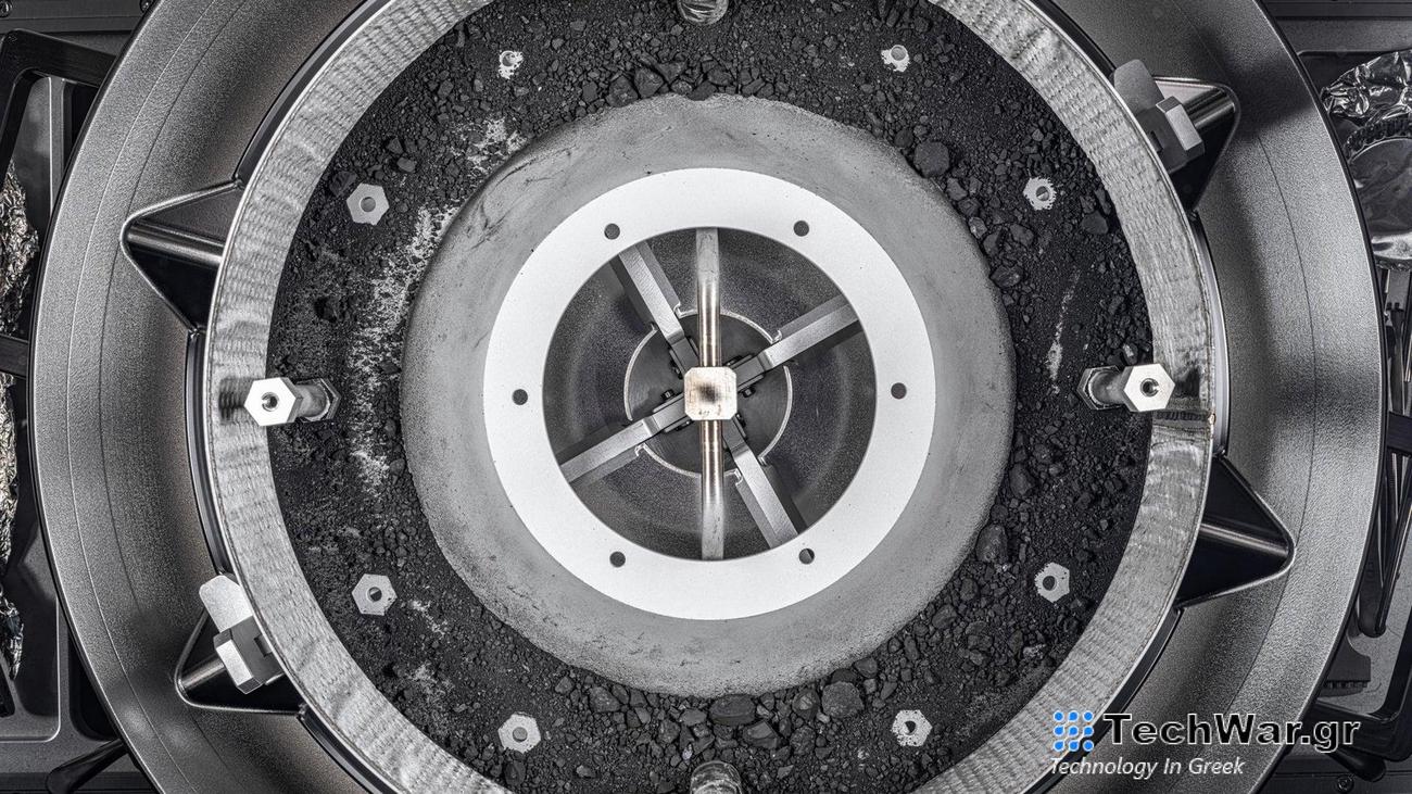 A top-down view of the OSIRIS-REx Touch-and-Go-Sample-Acquisition-Mechanism (TAGSAM) head with the lid removed, revealing the remainder of the asteroid sample inside. The picture was taken using manual high-resolution precision photography and a semi-automated focus stacking procedure. The result is an image that can be zoomed in on to show extreme detail of the sample. The remaining sample material includes dust and rocks up to about 0.4 inch in size.