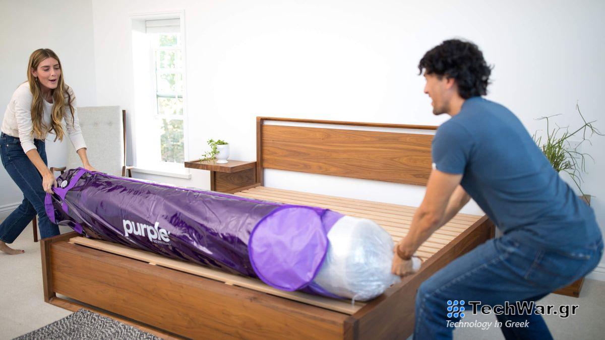 A man and a woman remove a Purple mattress from its packaging before it starts to expand, ready for sleeping on later