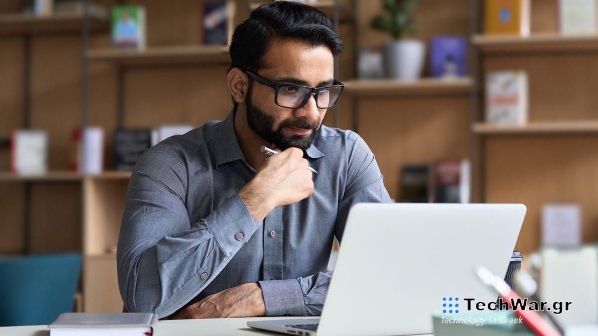 Man watching video on his laptop in office
