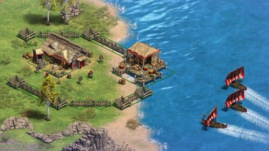 Age of Empires 2: Definitive Edition DLC Victors and Vanquiished - Τα σκάφη Βίκινγκ πλησιάζουν έναν μικρό οικισμό δίπλα στο νερό σε αυτό το κλασικό παιχνίδι στρατηγικής.