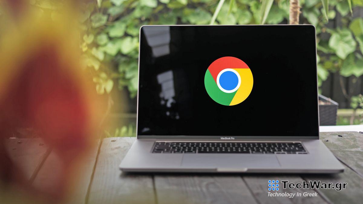 A photo of the Google Chrome logo on a black background, displayed on the screen of a large MacBook Pro which is situated on a table with green foliage behind.