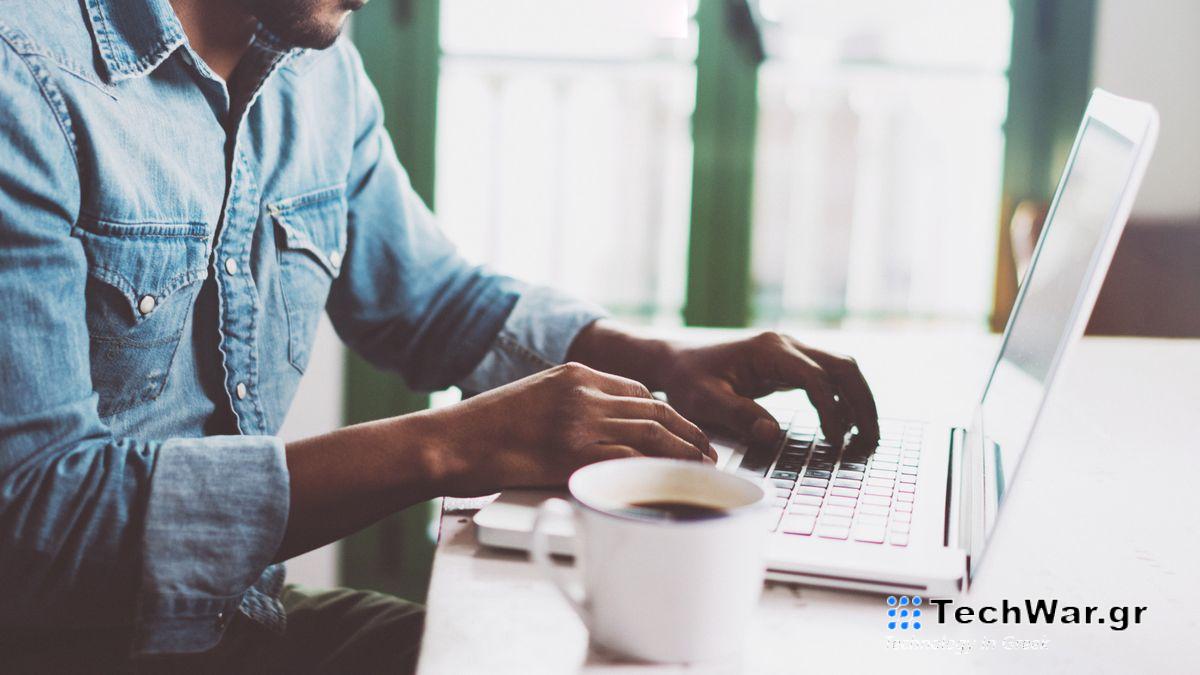 Man using laptop with a cup of coffee