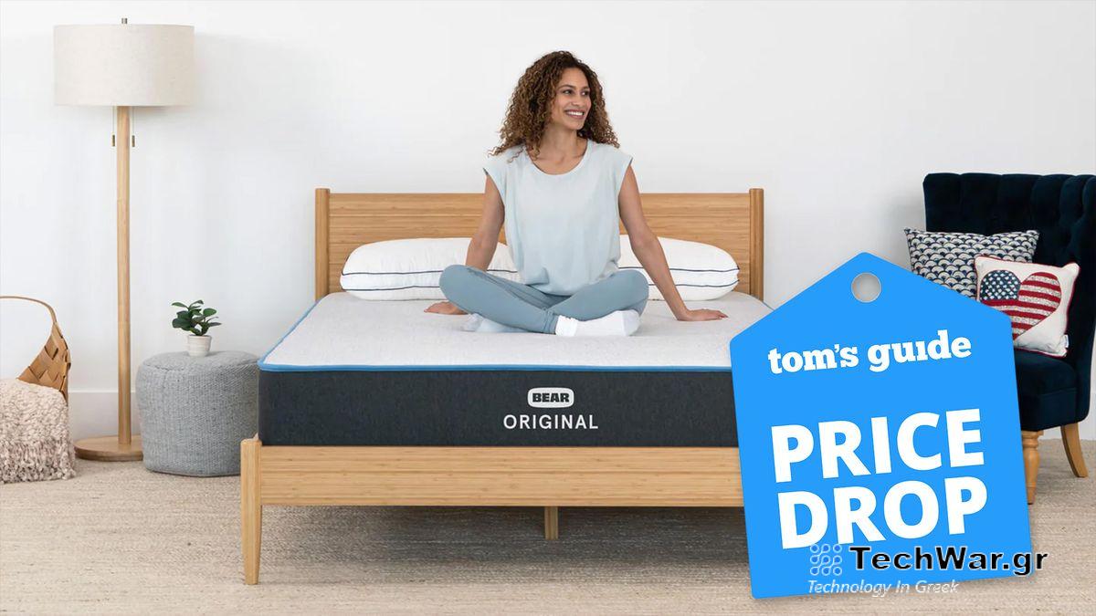 Bear Original Mattress image shows a woman with curly dark hair smiling and sitting cross-legged on the mattress, while a blue price drop sales badge overlaid on the image