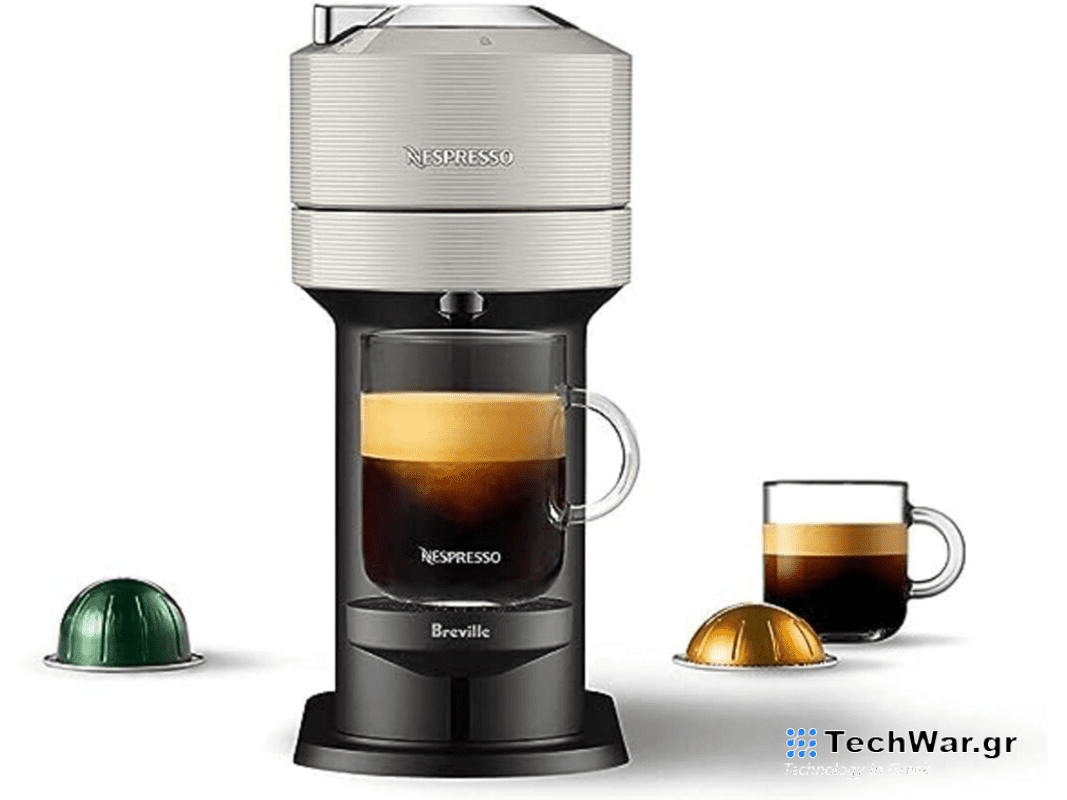 A grey open box Breville Nespresso machine on a plain background.