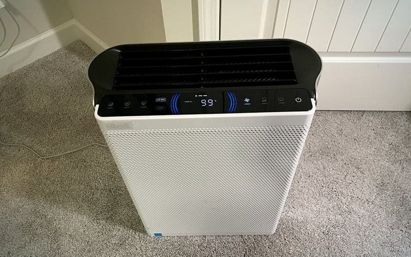 White rectangular Levoit EverestAir air purifier on carpet in front of white cabinets