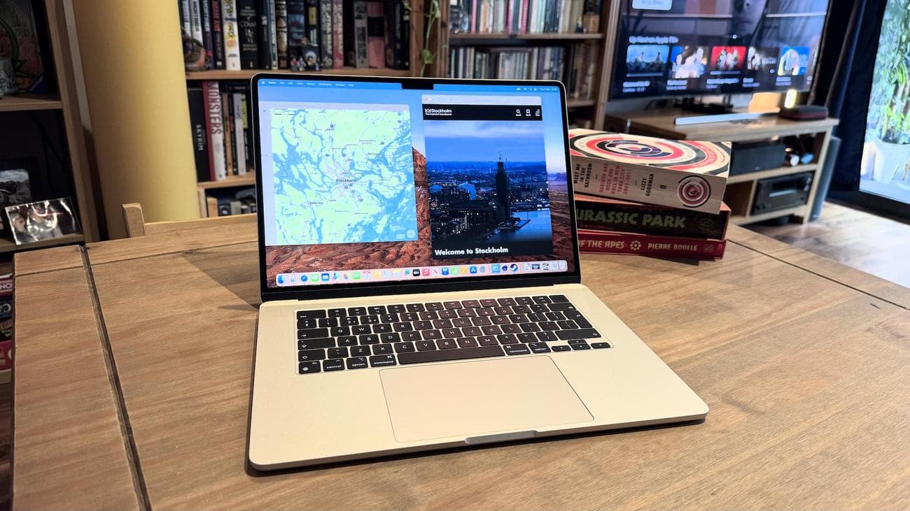 The 2024 MacBook Air M3 on a wooden table in front of a bookshelf.
