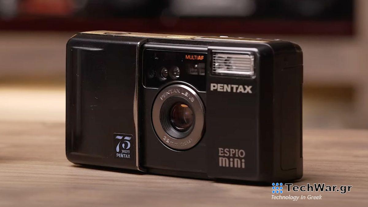 A Pentax Espio Mini film camera sitting on a table