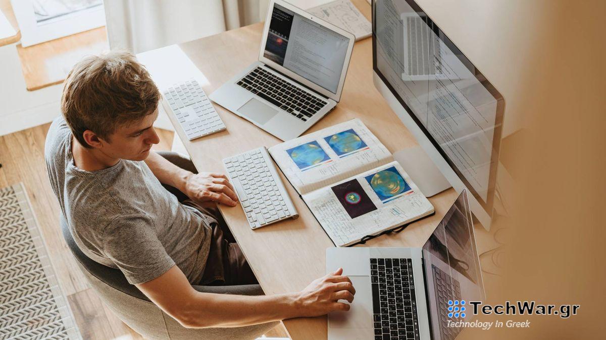 A person working from home using two laptops.