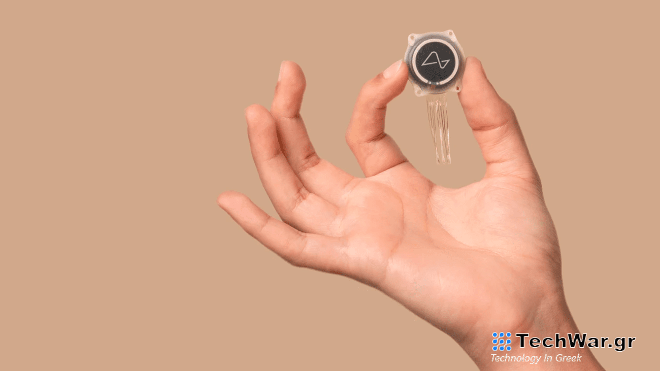 Hand holding up Neuralink brain implant